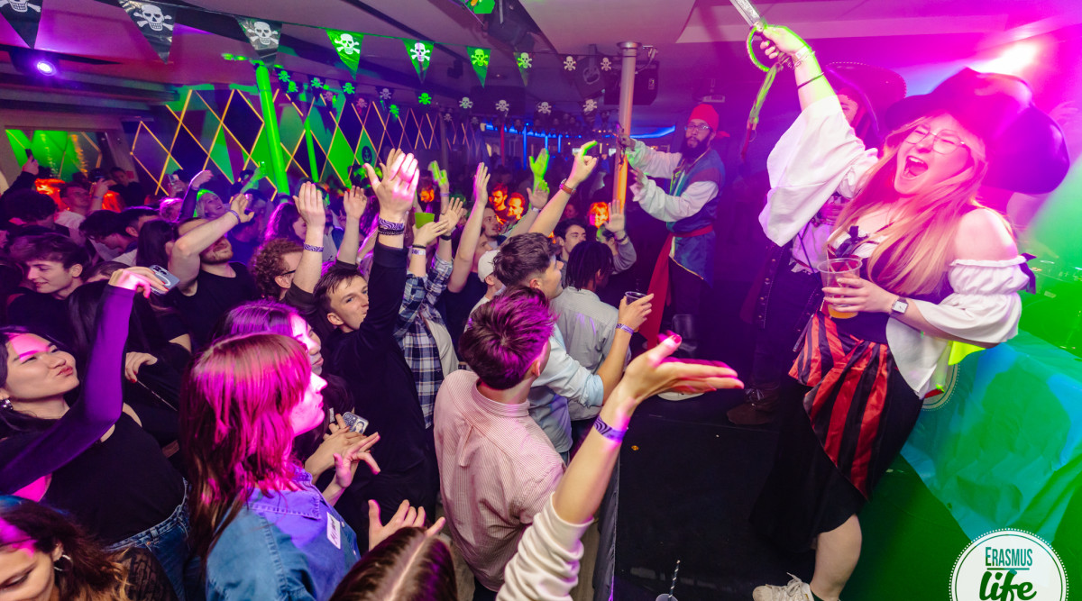 Group enjoying drinks at night event.