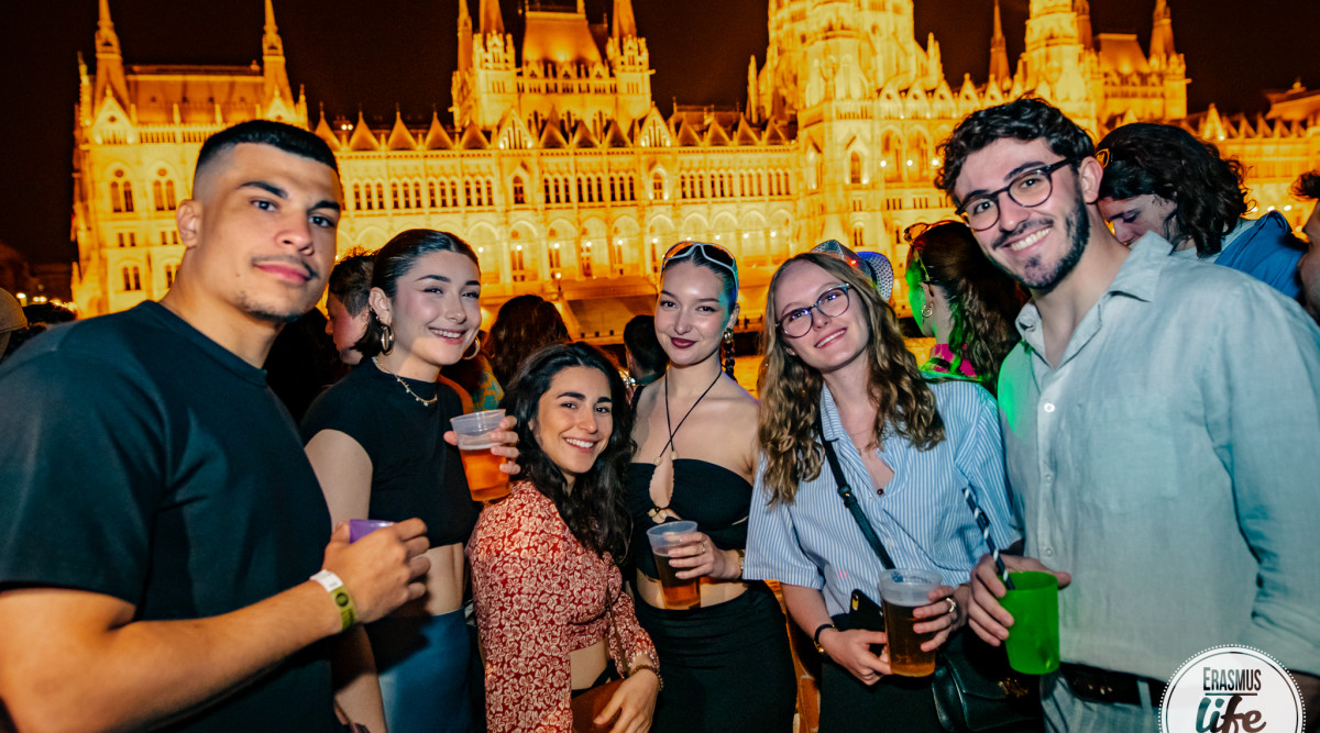 Crowded party with vibrant lights.