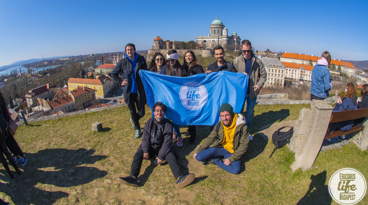 Group of people in sunny square.